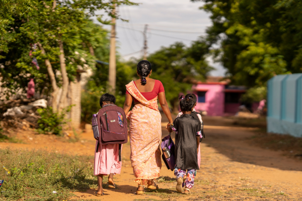 Mother walking children to school
