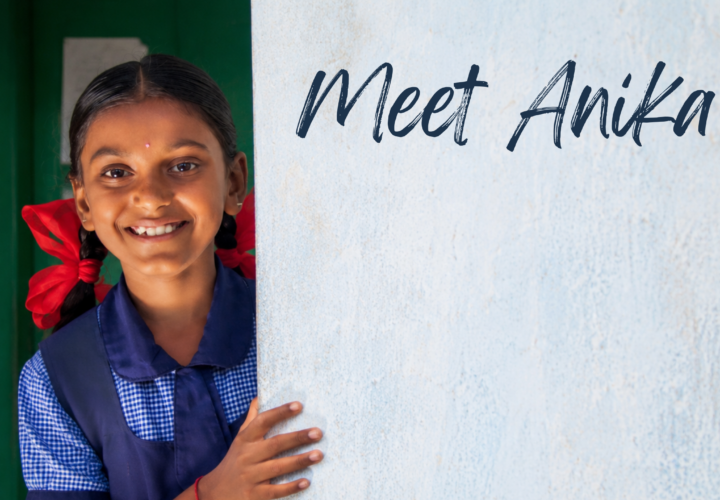 Anika peering around a wall in her school uniform